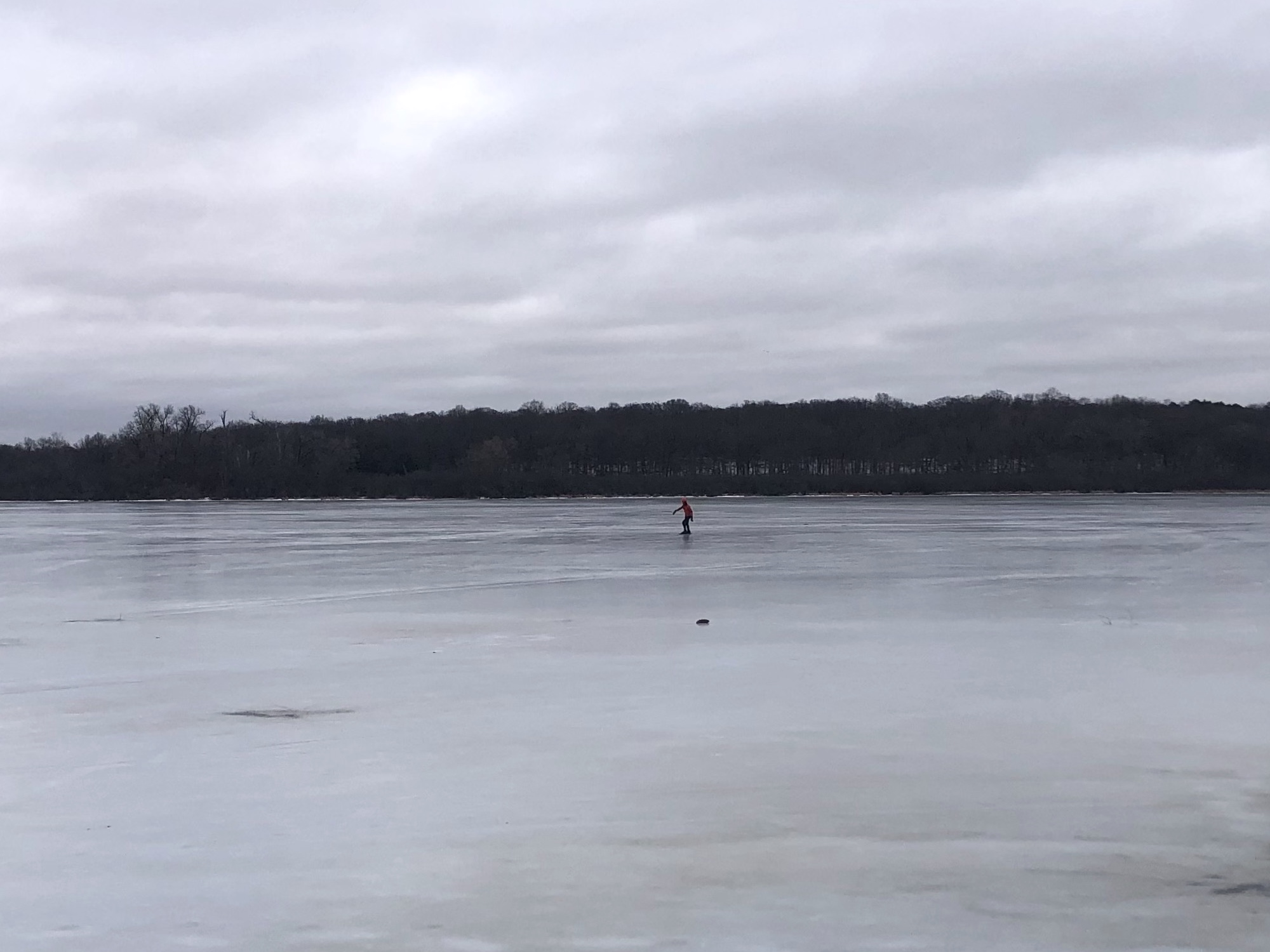 Ice skater circling Lake Wingra on on speed skates on February 16, 2023.